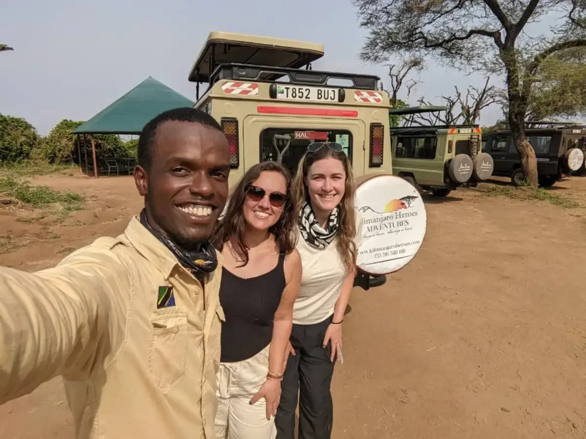 Our safari guide with guests in front of the fleet